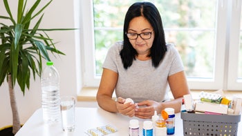 Bisacodyl: woman reading rx bottle 1424064778