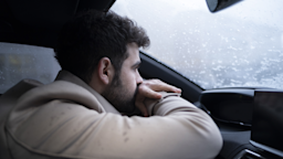 A man experiencing sadness leans against the steering wheel of his vehicle with an overwhelmed expression.
ridvan_celik/E+ via Getty Images 
