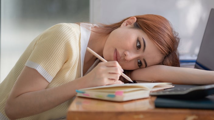 A person looking at their schedule book.