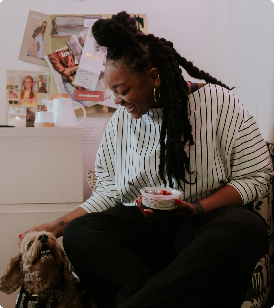 Right: portrait of Nikki at home sitting in her room petting her dog and smiling. She has a container of yogurt topped with berries in her hand.