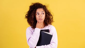 Health: adhd: portrait woman yellow background-1278445184