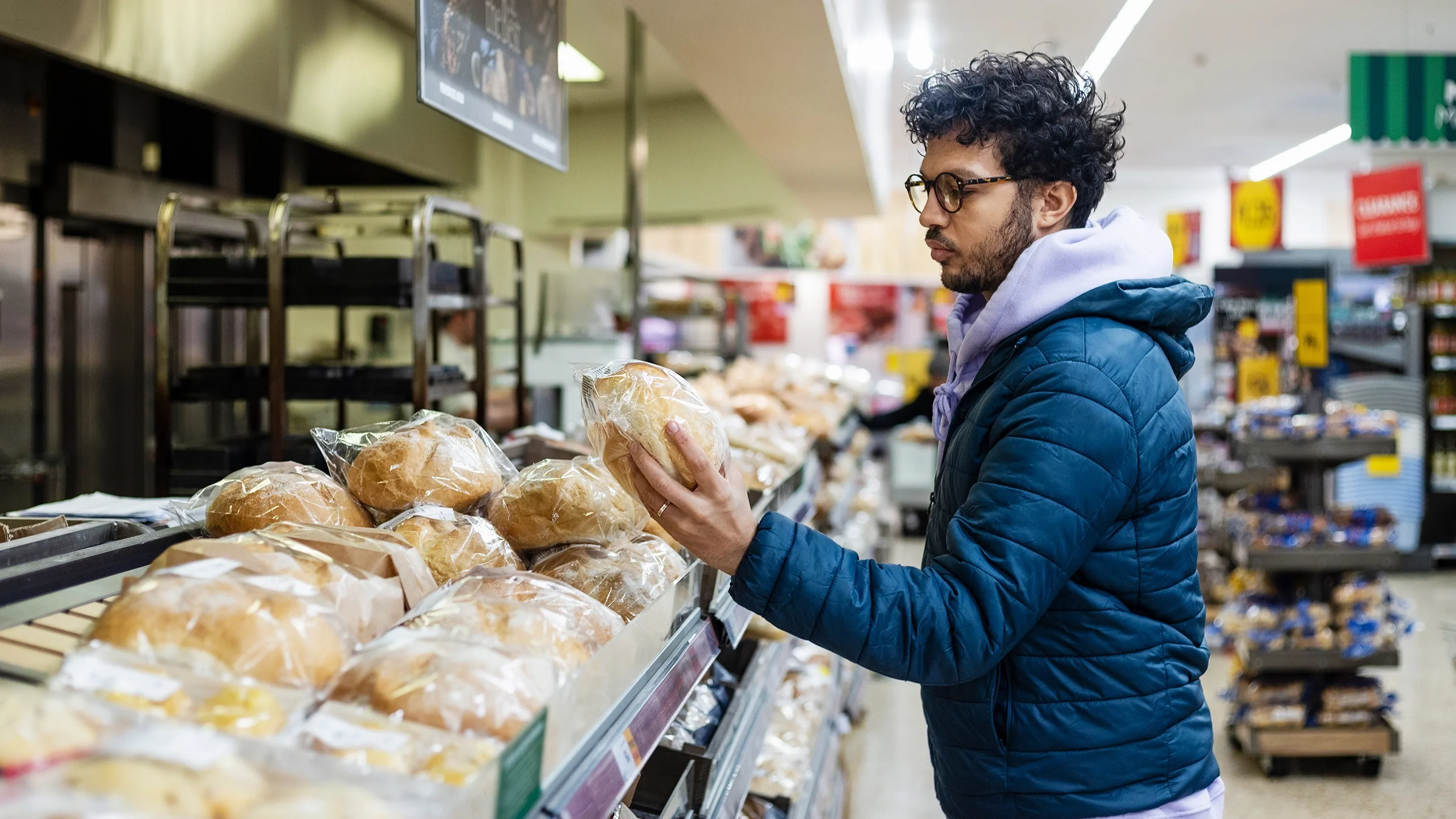 Man buying bread in a supermarket