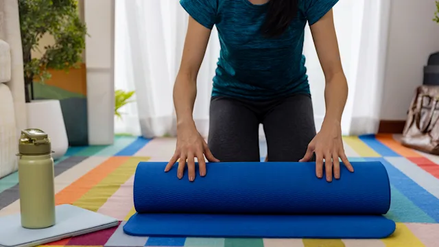 ptsd: woman rolling yoga mat 1442077311