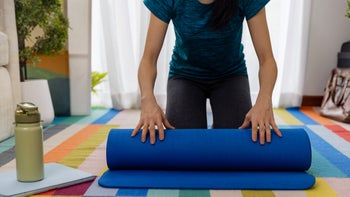 ptsd: woman rolling yoga mat 1442077311