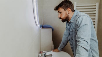 Mental health: man stressed and staring in mirror 1347126836