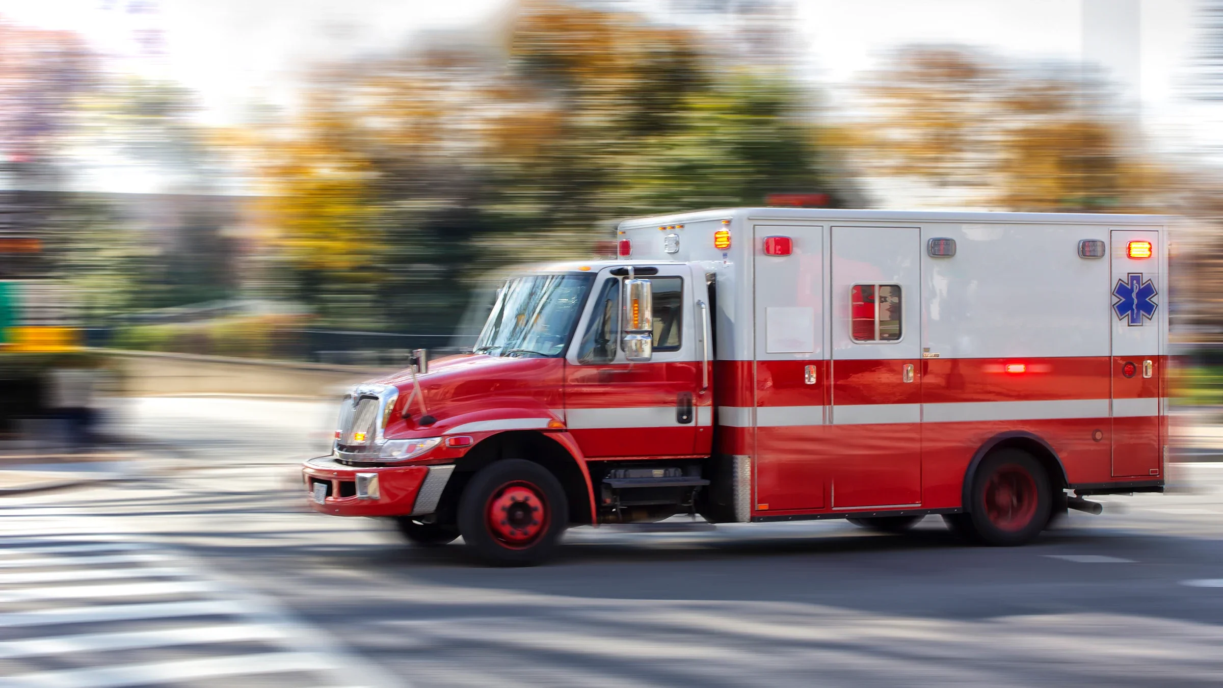 Speeding ambulance with blurry trees in the background.
wsfurlan/E+ via Getty Images