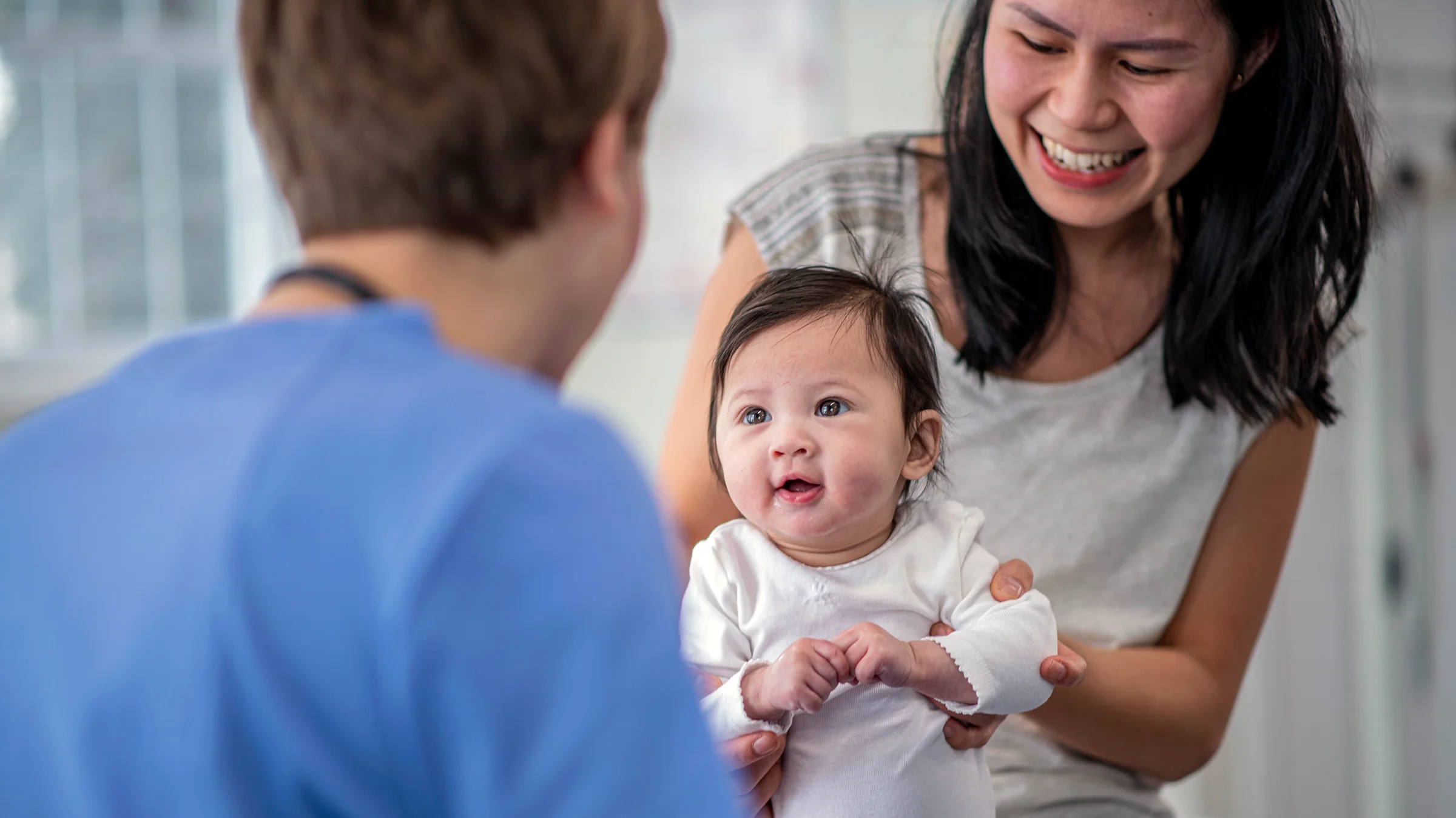 A mother brings her baby to a doctor for a check up.