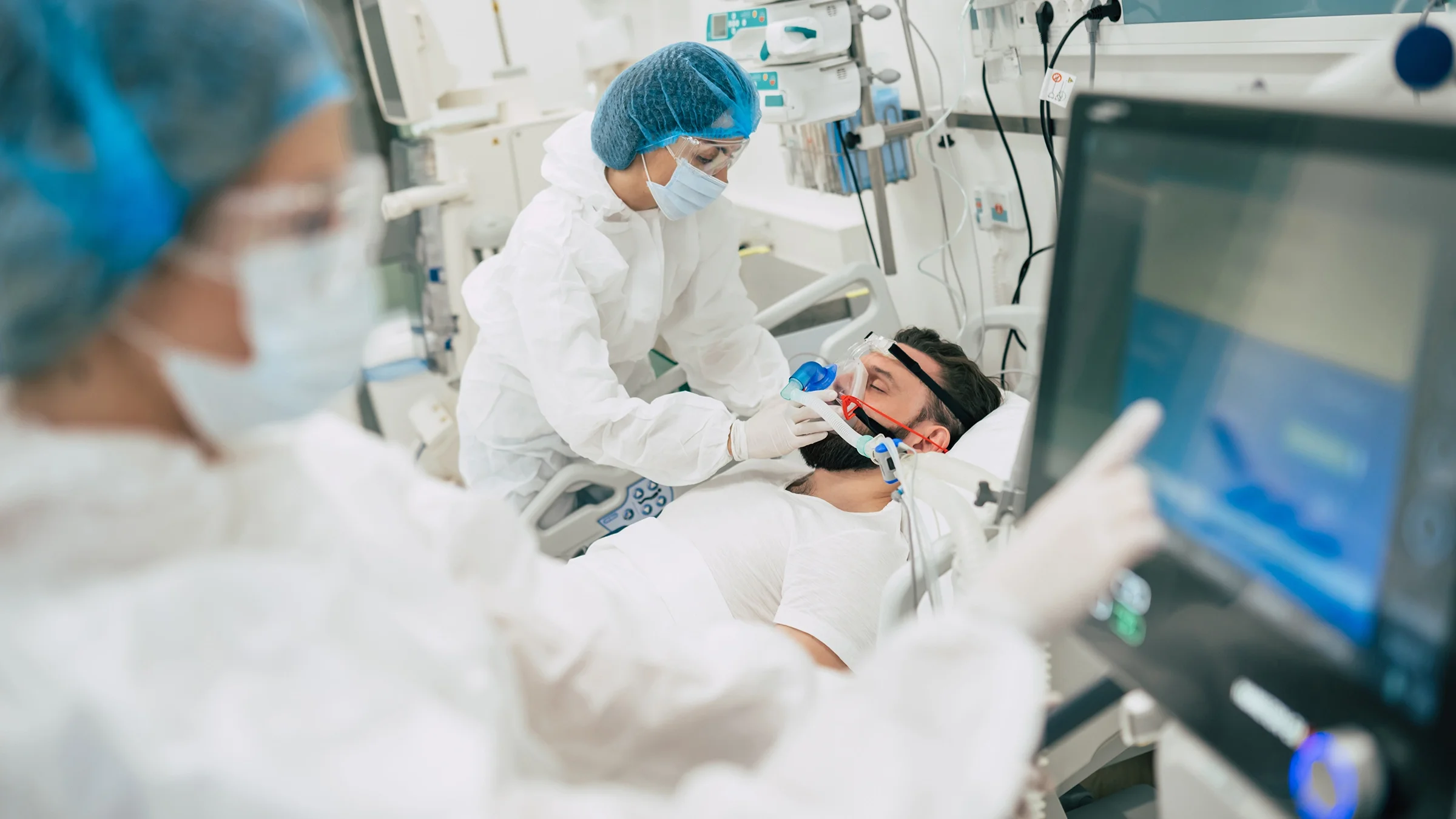 Doctors and nurses are tending to a patient on life support in the hospital.
