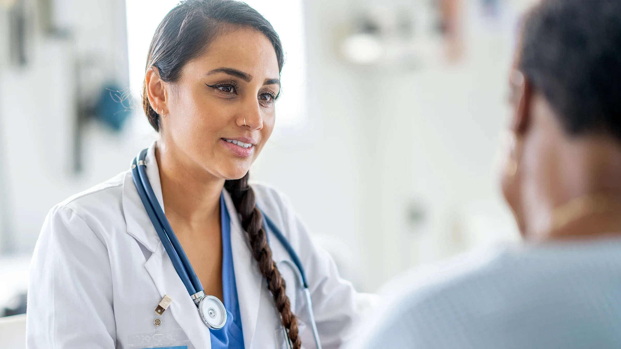 A healthcare professional speaks to a patient.