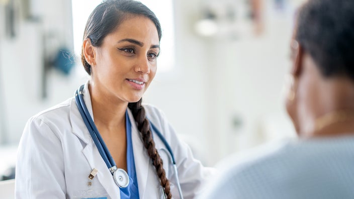 A healthcare professional speaks to a patient.