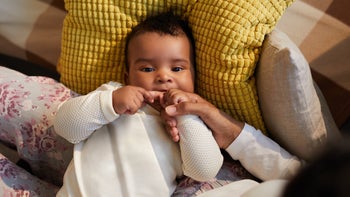 Children's health: baby finger in mouth while teething 1152209597