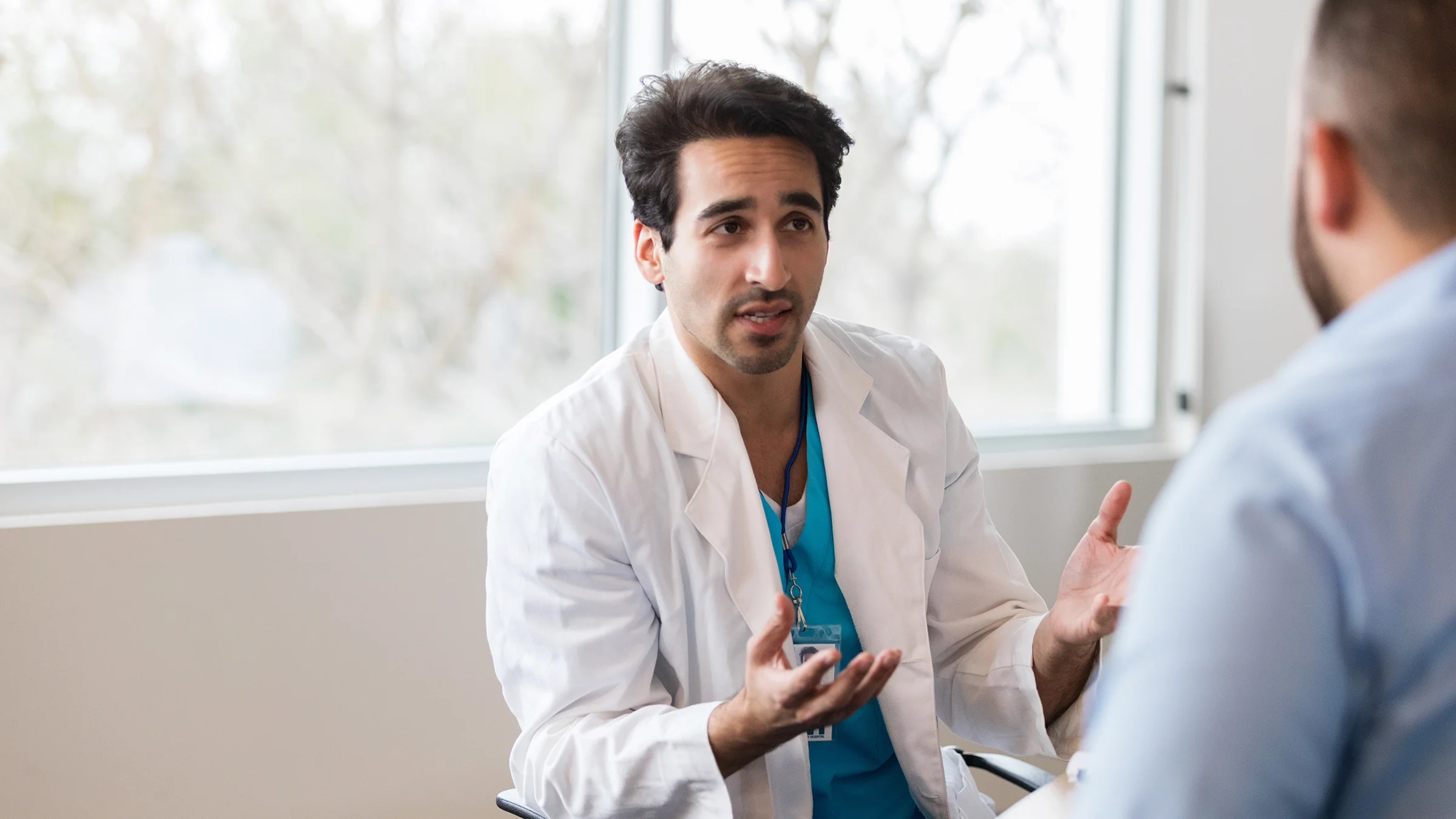 A doctor speaks to a patient.