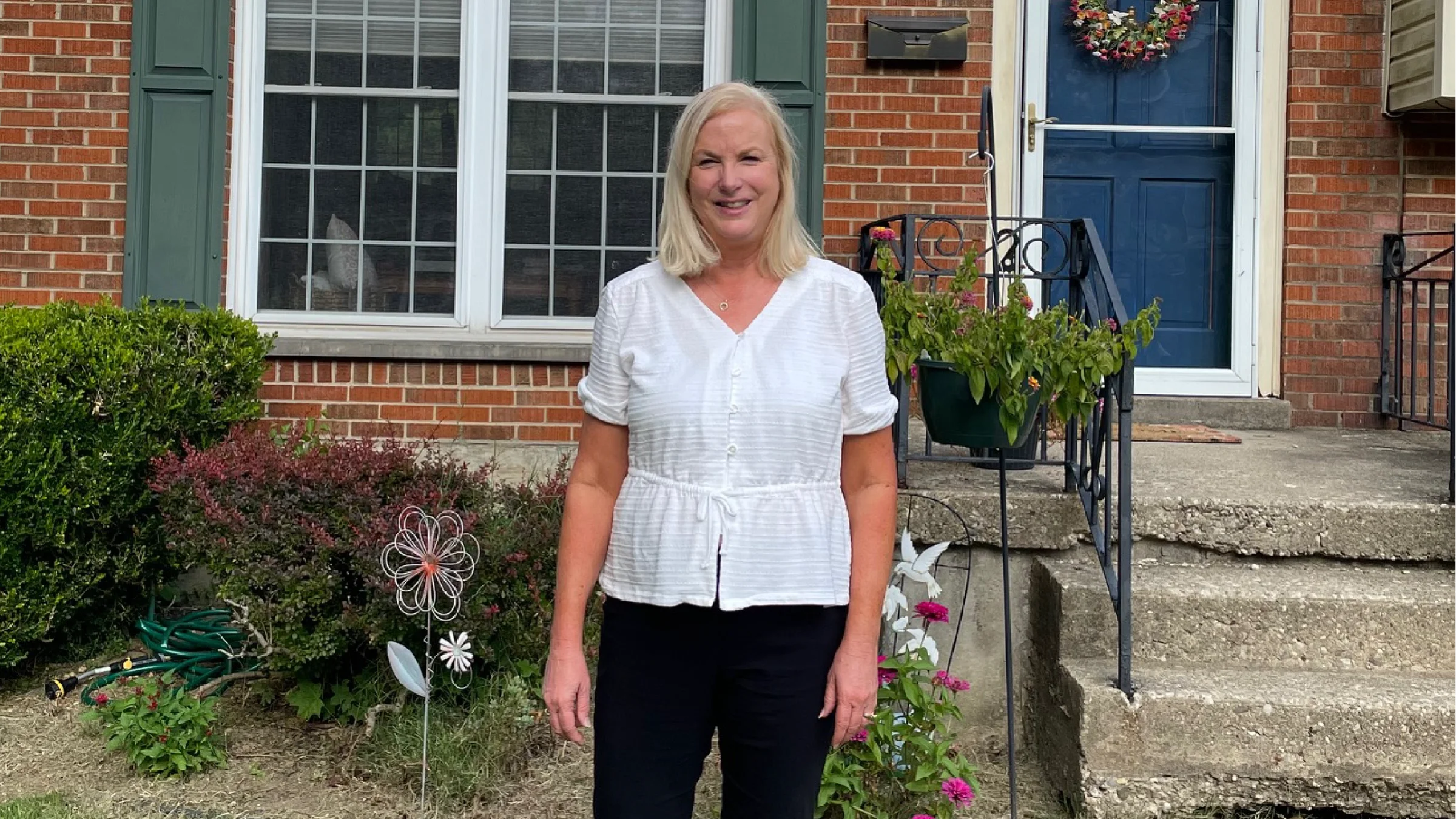 Nancy Porras in front of her house.