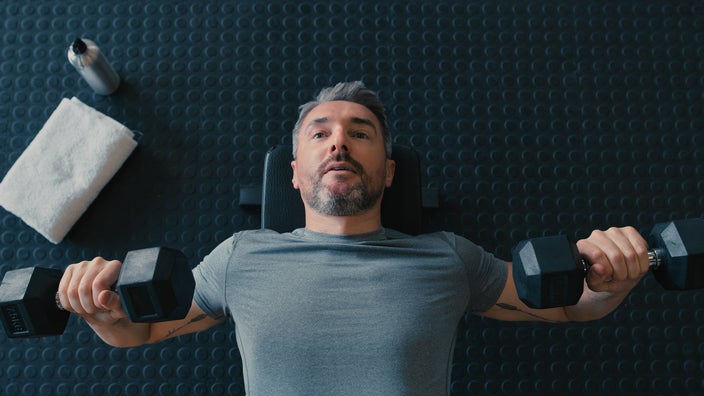A man lifts barbells.