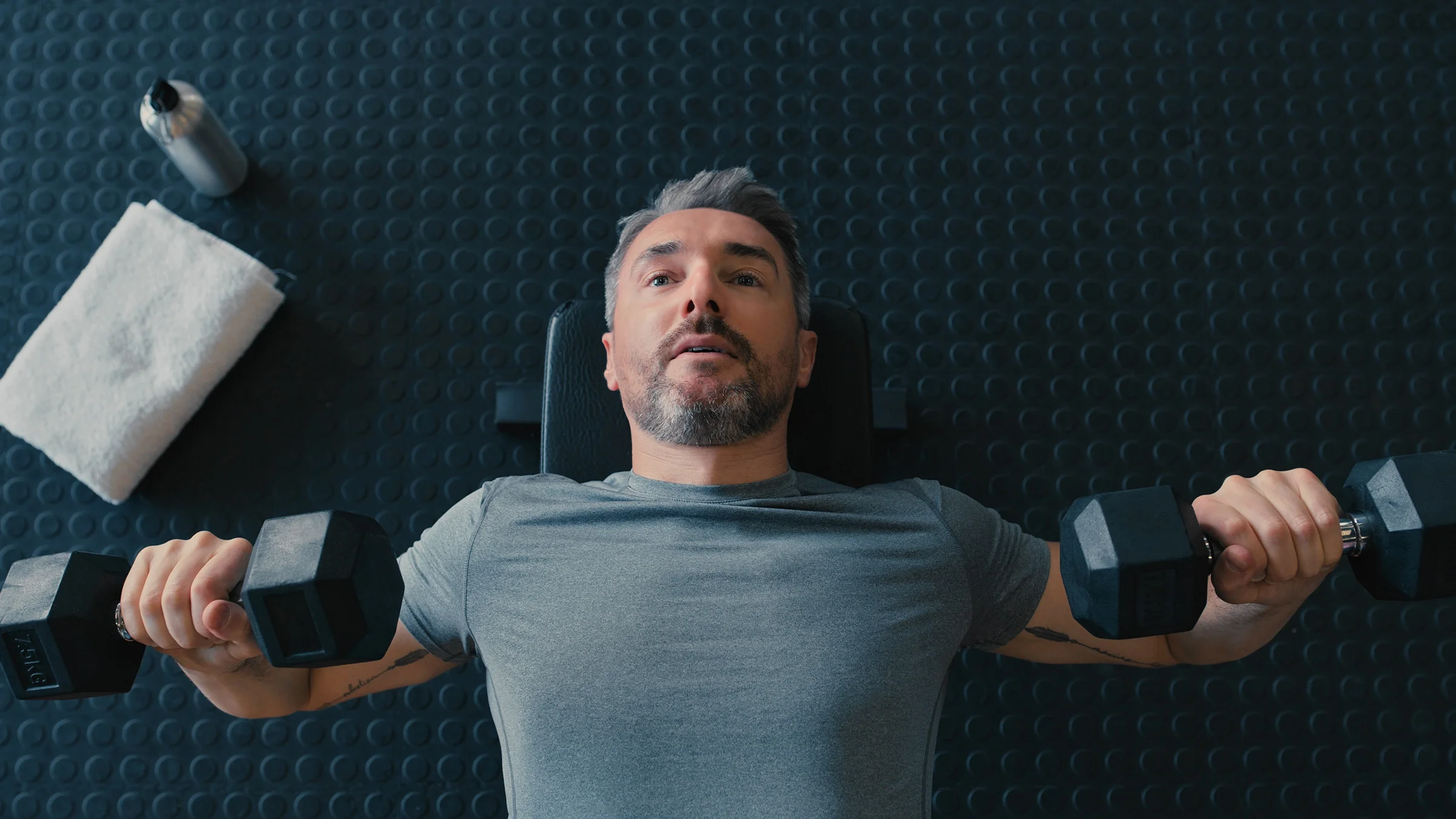 A man lifts barbells.