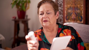 sglt2 inhibitors: warning: holding pill bottle and tablet 1051224442