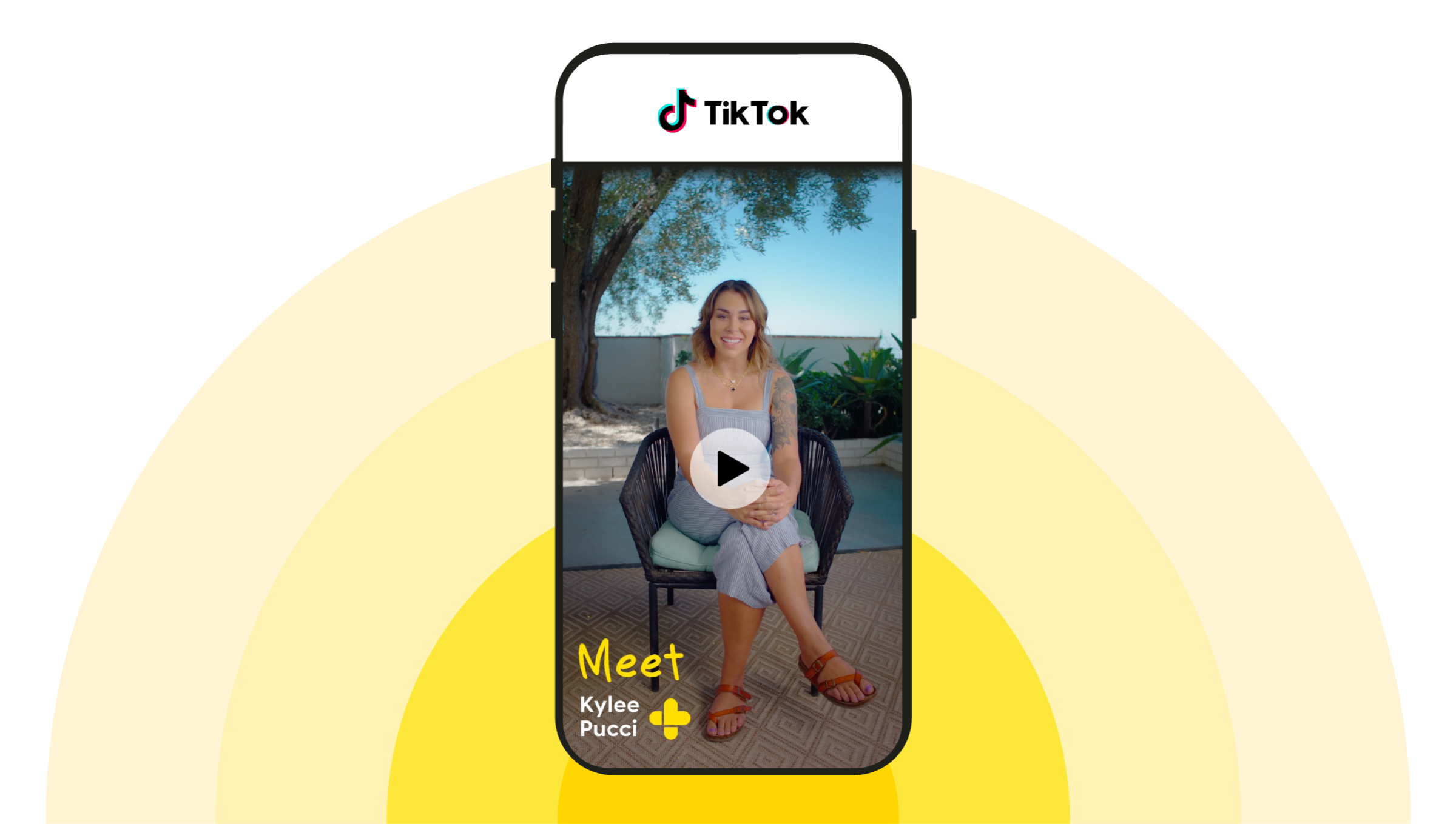 Custom graphic with a yellow sunburst behind a mock-up of a photo showing the GoodRx TikTok video of Kylee Pucci. 
GoodRx Health
