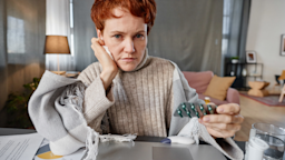 Senior woman holding a blister pack in a telehealth call.
mediaphotos/iStock via Getty Images Plus 