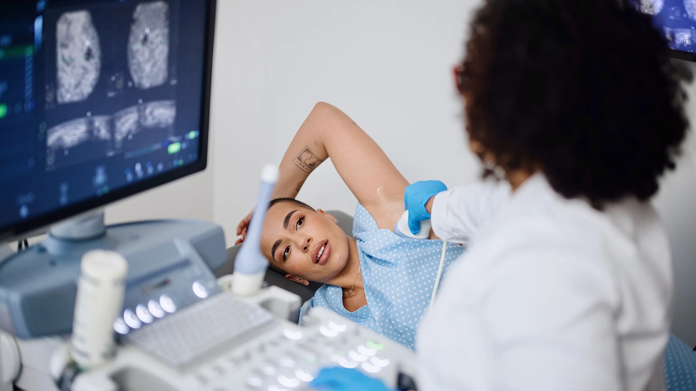 A woman receives a breast ultrasound.