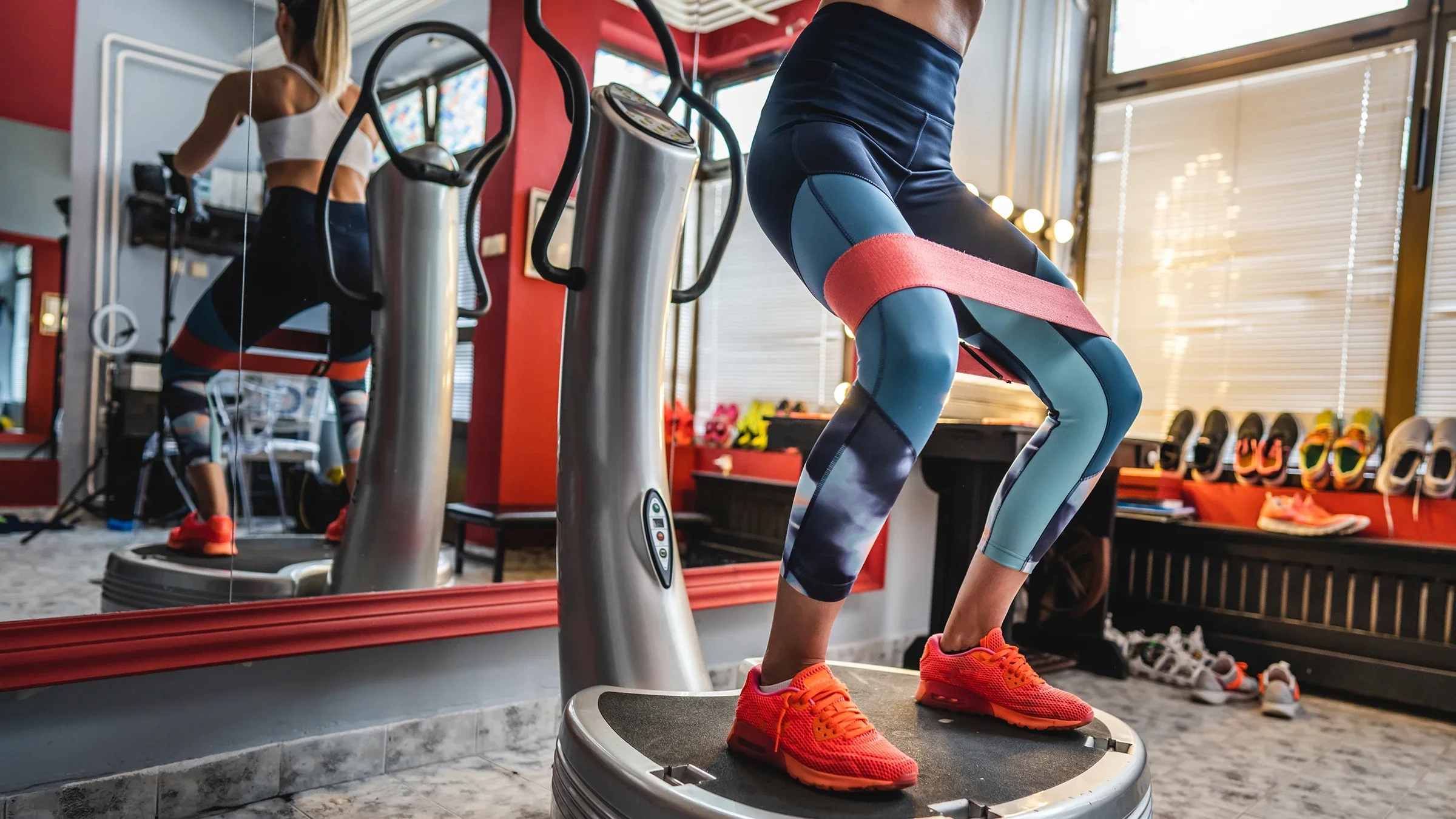 Close-up woman training on a power plate machine.