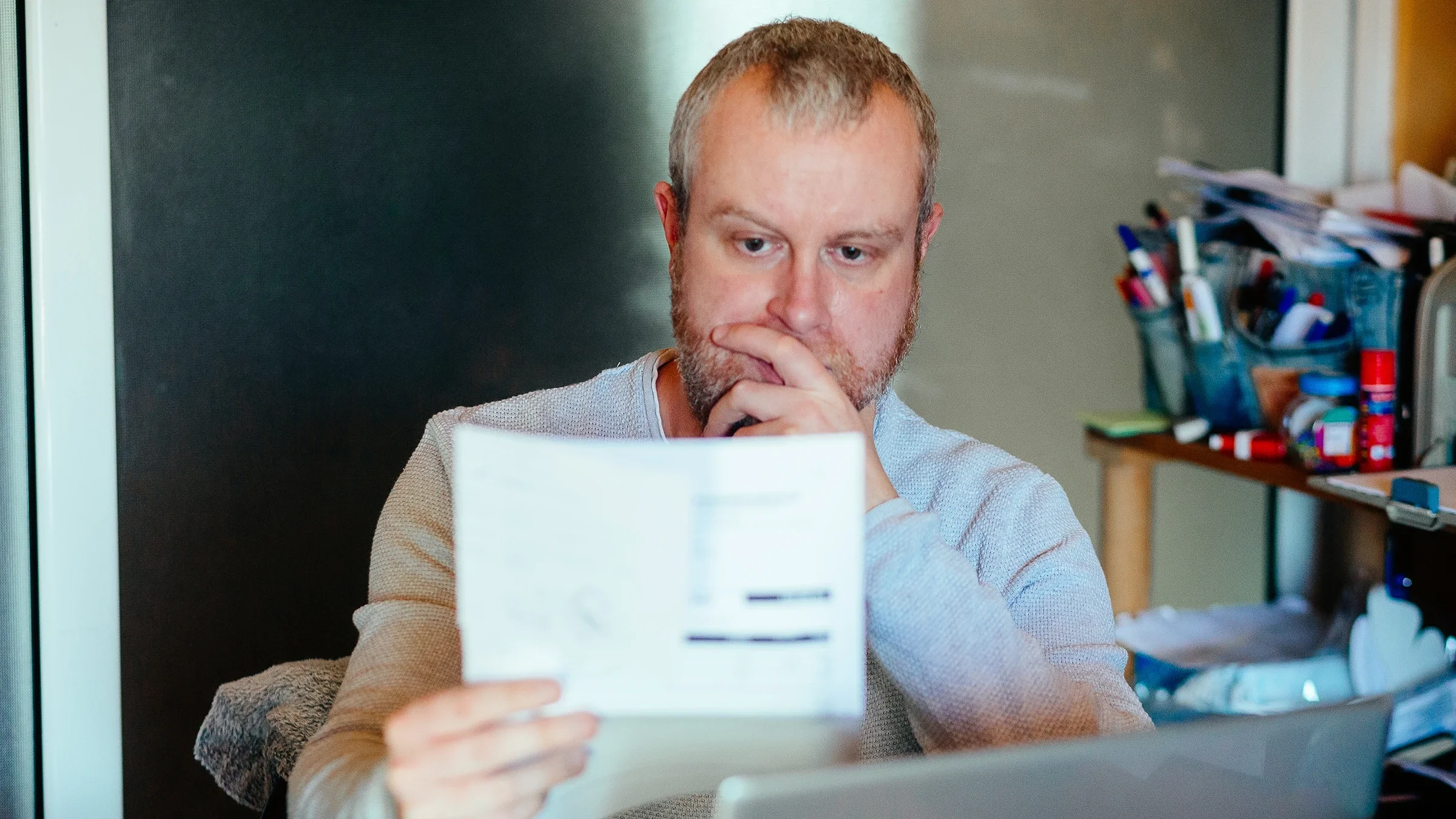 A man reads a medical bill.
