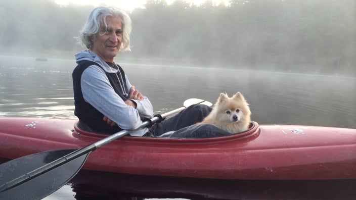 Richard Brockman is pictured with his dog in a kayak on the water.