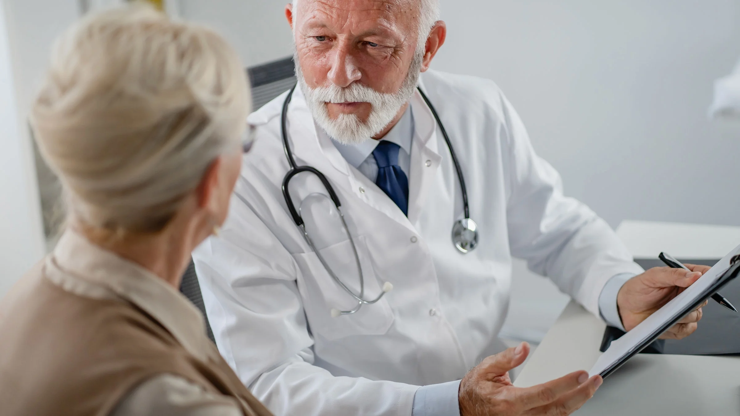 A doctor talking to an elderly patient.