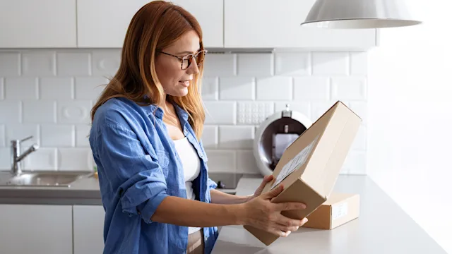 Testing: woman opens a package 2187434505