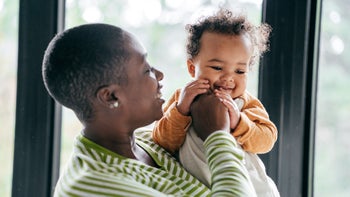 Health: Childrens health: mother holding teething baby 1092691488
