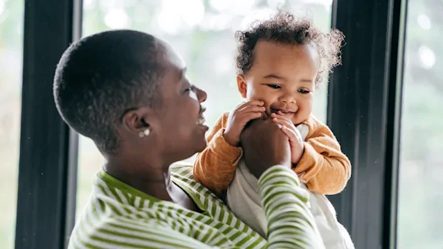 Health: Childrens health: mother holding teething baby 1092691488