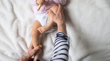 childrens health: hip adjusting baby on blanket 1204468329