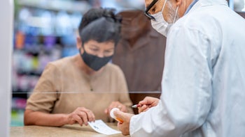 synthroid: woman checking out at pharmacy 1362615430
