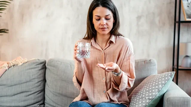 Medication Education: woman taking medication 2211960656