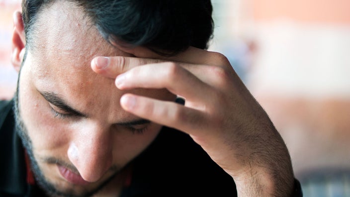 A man feels nauseous.