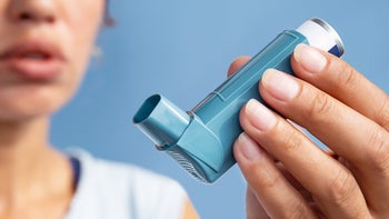 Respiratory: closeup woman holding inhaler 1762594149