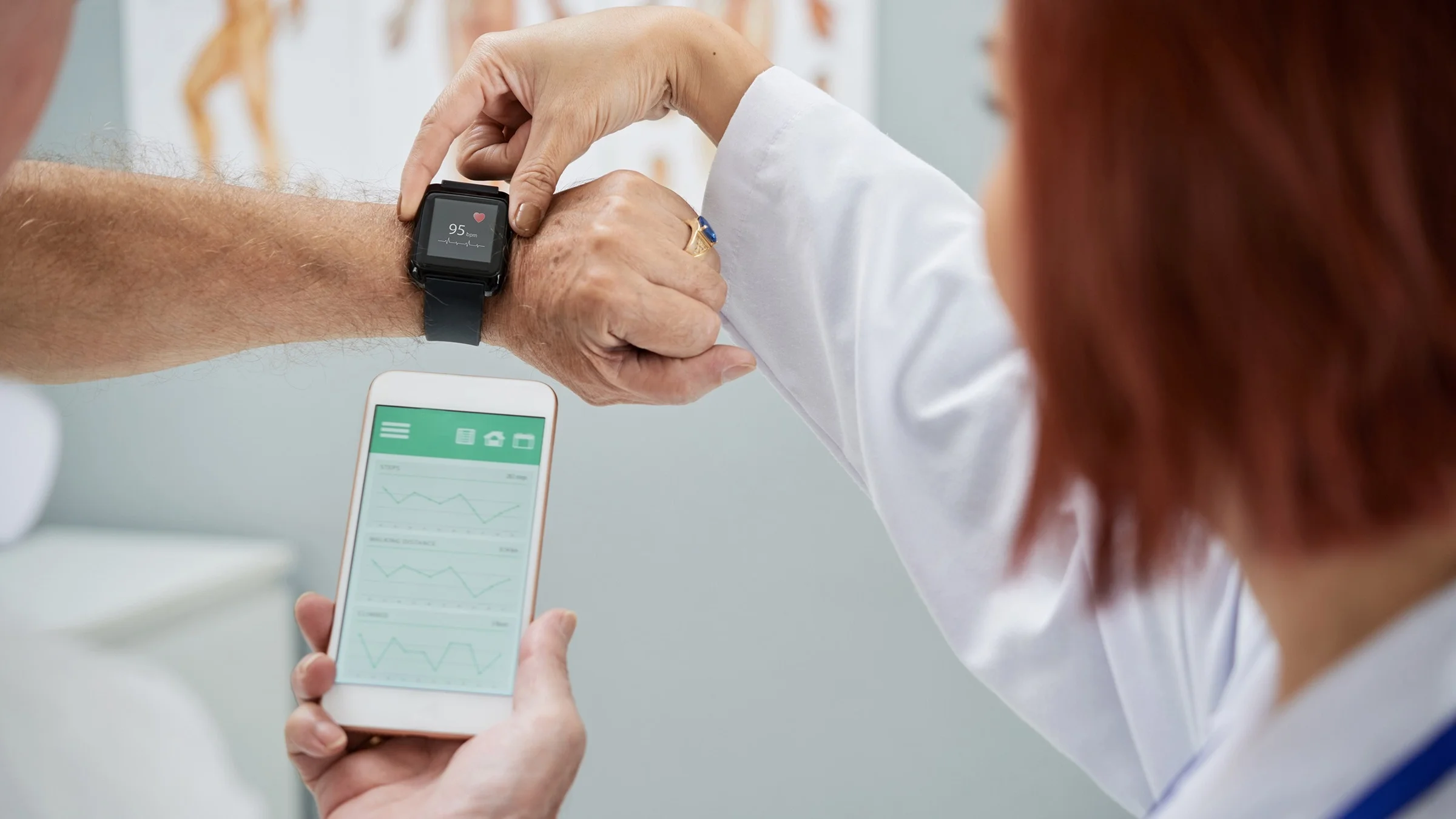 Doctor helping a patient sync their digital health device to their phone app.