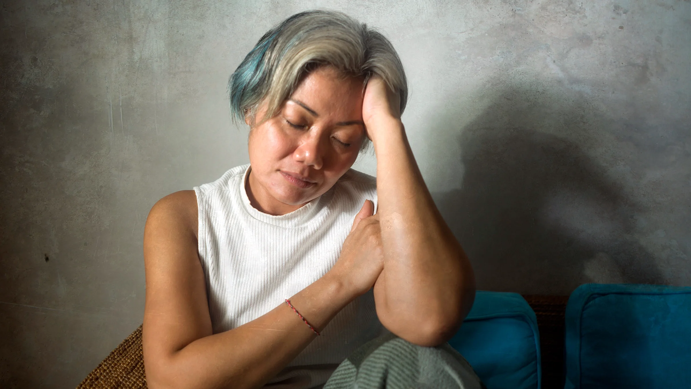Woman sitting on the couch feeling light-headed