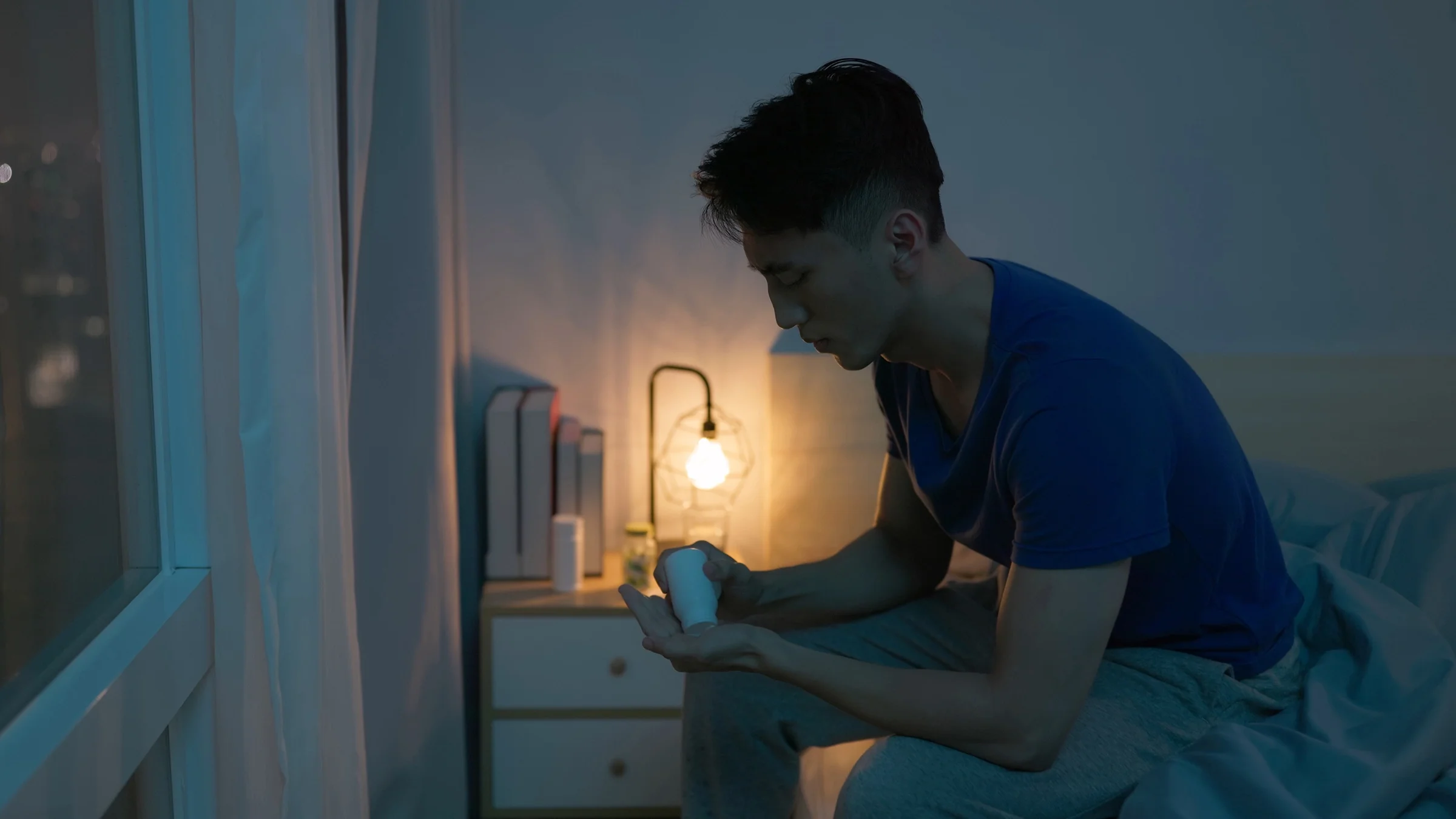 A man takes pills before going to bed.