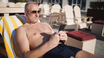 Herpes: man using phone by the pool 2149080892
