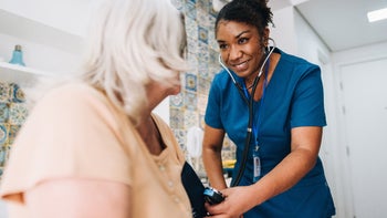 Hypertension: taking blood pressure of senior woman 1629901195