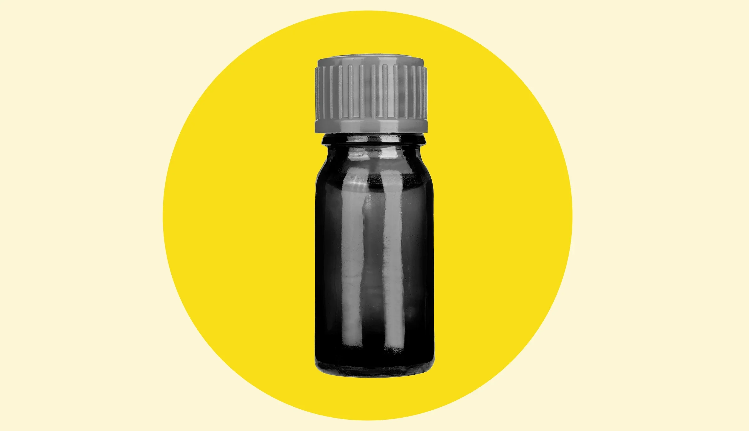 Black and white image of a glass medicine bottle with a yellow graphic circle behind it on a white background.
MAXSHOT/iStock via Getty Images