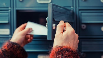 Taxes: 1095-A: taking envelope out of mailbox 480197395