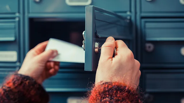 Taxes: 1095-A: taking envelope out of mailbox 480197395