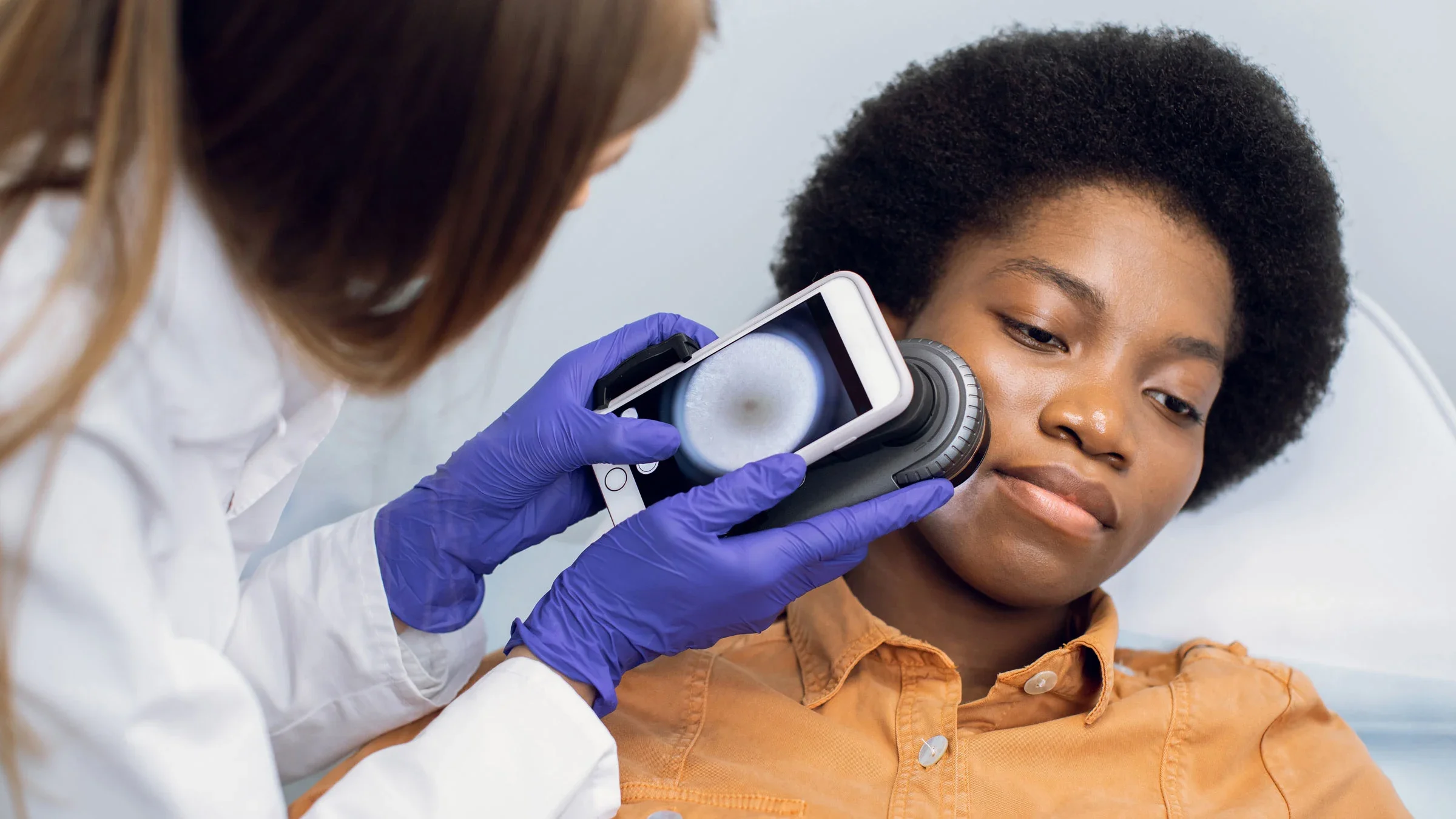 A doctor uses a dermatoscope to analyze the patient’s face for any skin conditions.
undefined undefined/iStock via Getty Images