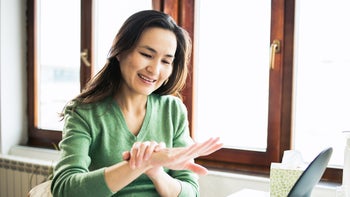 Dupixent: woman looking at her hand 1474726177