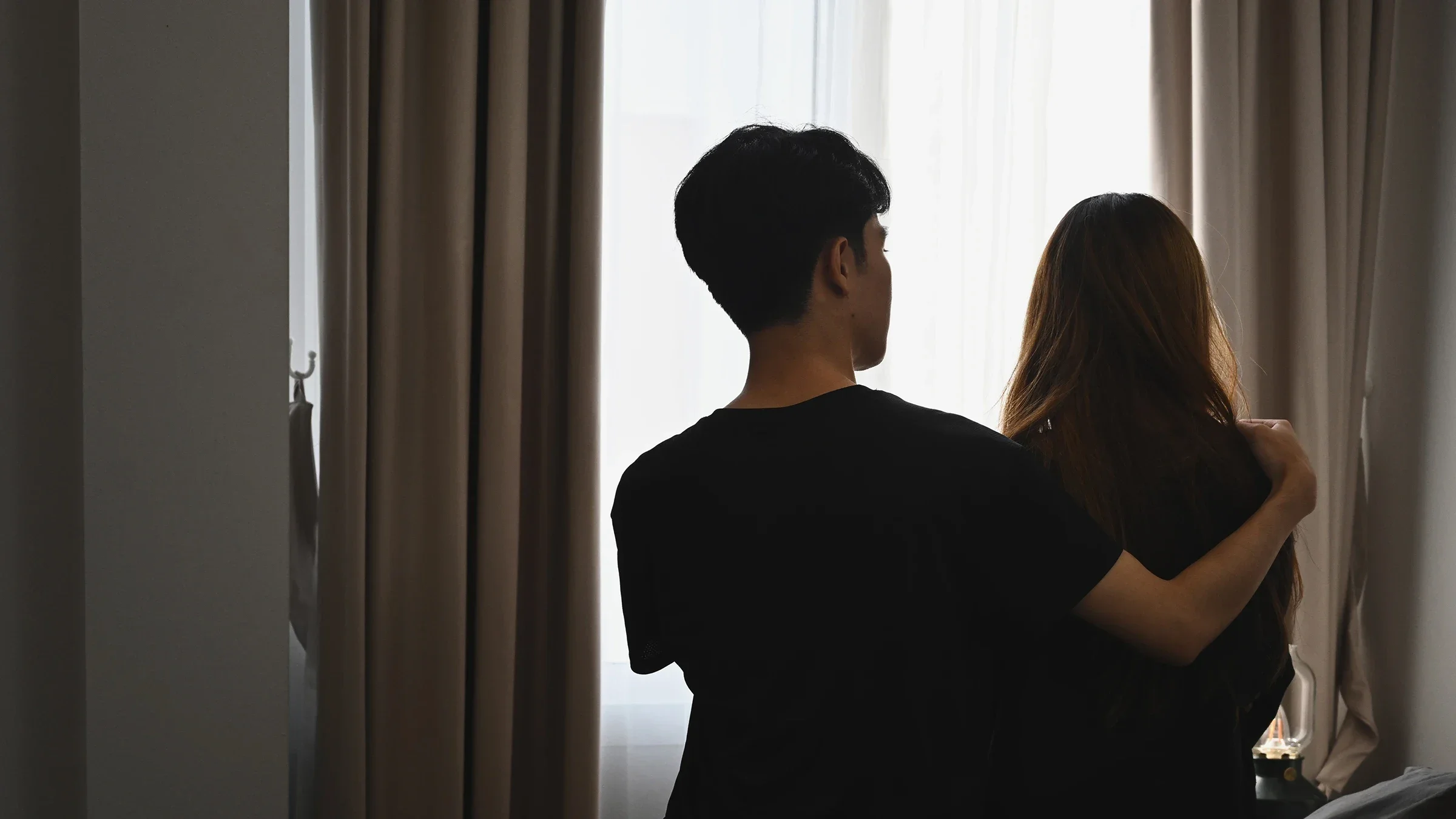 A man comforts a woman while sitting in a bedroom.
PrathanChorruangsak/iStock via Getty Images Plus    