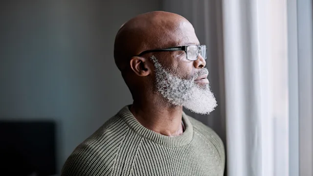 Mental health: man looking out the window 1202258608