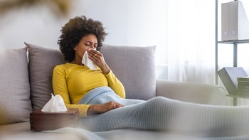 Health: Upper respiratory infection: woman blowing nose 1149520802