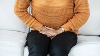 Health: Vivjoa: person pressing hands onto pelvis 1076053890