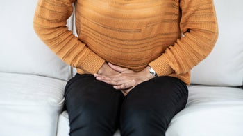 Health: Vivjoa: person pressing hands onto pelvis 1076053890